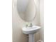 Modern powder room featuring a pedestal sink and oval mirror at 2103 Glenkirk Dr, Burlington, NC 27215
