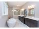 Luxurious bathroom featuring a soaking tub, dark wood cabinets, dual sinks, and a glass-enclosed shower at , Chapel Hill, NC 27514