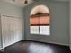 Bright bedroom with a large arched window, closet, and hardwood floors at 2124 Claret Ln, Morrisville, NC 27560