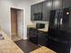 Updated kitchen with black appliances, granite countertops, and ample cabinet space at 2124 Claret Ln, Morrisville, NC 27560