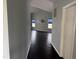 Hallway view into the living room boasting a high ceiling, and dark hardwood flooring at 2124 Claret Ln, Morrisville, NC 27560