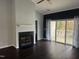 Open living room featuring a fireplace, hardwood floors, and a sliding glass door to the outside patio at 2124 Claret Ln, Morrisville, NC 27560