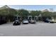 Exterior view of the parking lot in front of the condos and mature trees surrounding at 2124 Claret Ln, Morrisville, NC 27560
