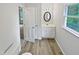 Updated bathroom features modern vanity, new lighting fixtures, and stylish wood-look flooring at 213 Dwelling Pl, Knightdale, NC 27545