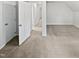 Carpeted room with two doors, neutral paint, and a view into the hall at 213 Dwelling Pl, Knightdale, NC 27545