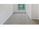 Spacious bedroom features plush carpeting, neutral paint, and a view to the outdoors from a window at 213 Dwelling Pl, Knightdale, NC 27545