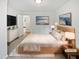 Bright bedroom with a neutral palette features a light wood bed frame and stylish decor at 213 Dwelling Pl, Knightdale, NC 27545