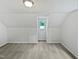 Finished attic room with a window, carpeted flooring, and neutral paint at 213 Dwelling Pl, Knightdale, NC 27545