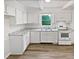 Bright, all-white kitchen features granite countertops and modern appliances for a clean aesthetic at 213 Dwelling Pl, Knightdale, NC 27545