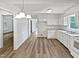Bright kitchen featuring white cabinets, new countertops, and modern wood-look flooring for a fresh look at 213 Dwelling Pl, Knightdale, NC 27545