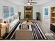 Bright living room featuring a brick fireplace, modern furnishings, and large windows at 213 Dwelling Pl, Knightdale, NC 27545