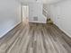 A light-filled living room boasts hard surface flooring and a seamless transition to the staircase and other rooms at 213 Dwelling Pl, Knightdale, NC 27545