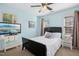 Comfortable bedroom with a ceiling fan, stylish furnishings, and two windows offering plenty of natural light at 213 Meadow Fox Rd, Holly Springs, NC 27540