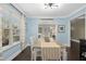 Bright dining room with stylish furnishings, hardwood floors, lots of light, and a passthrough to the living room at 213 Meadow Fox Rd, Holly Springs, NC 27540