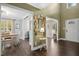 Spacious foyer with hardwood floors and decorative wall art, leading to dining and living areas at 213 Meadow Fox Rd, Holly Springs, NC 27540