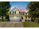 Charming two-story home with a well-manicured lawn, attached garage, and inviting front porch perfect for families at 213 Meadow Fox Rd, Holly Springs, NC 27540