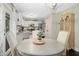 Eat-in kitchen with stainless steel appliances, white cabinets, and a dining area at 213 Meadow Fox Rd, Holly Springs, NC 27540