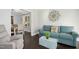 Comfortable living room, hardwood floors, doorways to dining area, comfortable sofa, and decorative wall art at 213 Meadow Fox Rd, Holly Springs, NC 27540