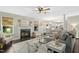 Bright living room with fireplace and hardwood floors leading into a modern kitchen at 213 Meadow Fox Rd, Holly Springs, NC 27540