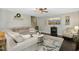 Cozy living room with dark hardwood floors, a decorative rug, and modern furnishings at 213 Meadow Fox Rd, Holly Springs, NC 27540