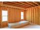 Bedroom showing open ceiling, wall studs, and window at 2305 Ballywater Lea Way, Wake Forest, NC 27587