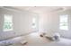 Bright and airy bedroom featuring decorative wall paneling, large windows, and ample natural light at 2305 Ballywater Lea Way, Wake Forest, NC 27587