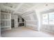 Unfinished bonus room featuring dormer, window and built-in cabinets; customize to your liking at 2305 Ballywater Lea Way, Wake Forest, NC 27587