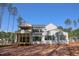 Back exterior of a two story home with a screened in porch and large windows at 2305 Ballywater Lea Way, Wake Forest, NC 27587
