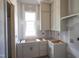 Unfinished kitchen featuring white cabinets, black hardware, window with natural light; customize to your liking at 2305 Ballywater Lea Way, Wake Forest, NC 27587