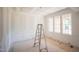 Bright, unfinished living room with custom trim work, paneling, and natural light from large windows at 2305 Ballywater Lea Way, Wake Forest, NC 27587