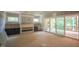 Spacious unfinished living room with a fireplace, built-in cabinets, and access to a screened porch at 2305 Ballywater Lea Way, Wake Forest, NC 27587