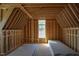 Spacious attic framing displaying wooden support beams and a window at 2305 Ballywater Lea Way, Wake Forest, NC 27587