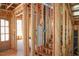 Unfinished staircase showing studs, exposed ceiling, and entryway at 2305 Ballywater Lea Way, Wake Forest, NC 27587