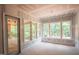 Bright sunroom featuring multiple windows offering panoramic views and a doorway to a screened porch at 2305 Ballywater Lea Way, Wake Forest, NC 27587