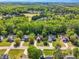 Aerial view of a residential street with well-maintained homes and lush green trees at 262 Windgate Dr, Clayton, NC 27527