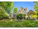 Backyard featuring a patio, a well-maintained lawn, and lush trees at 262 Windgate Dr, Clayton, NC 27527