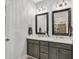 Bathroom with double sink vanity, framed mirrors, and modern fixtures creating a functional space at 262 Windgate Dr, Clayton, NC 27527