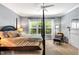 Bright bedroom with a four poster bed, neutral carpet, and a pair of windows letting in plenty of natural light at 262 Windgate Dr, Clayton, NC 27527