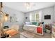 Bright bedroom featuring a daybed, desk, and a large window with natural light, a perfect room at 262 Windgate Dr, Clayton, NC 27527