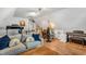 Bonus room featuring a sofa, treadmill, and a desk area, all on wood flooring at 262 Windgate Dr, Clayton, NC 27527