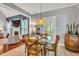 Dining area showcasing a round glass table, wood chairs, and a view into the living room at 262 Windgate Dr, Clayton, NC 27527