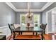 Dining room with wainscoting, coffered ceiling and an elegant chandelier at 262 Windgate Dr, Clayton, NC 27527