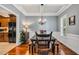 Traditional dining room with hardwood floors, gray walls, coffered ceilings, and decorative chandelier at 262 Windgate Dr, Clayton, NC 27527