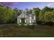 Charming home featuring lush landscaping and a well-maintained lawn, illuminated by landscape lighting at 262 Windgate Dr, Clayton, NC 27527