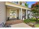 Inviting front porch with seating, stylish decor, and attractive front door at 262 Windgate Dr, Clayton, NC 27527