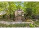 Charming greenhouse amidst a garden with stone pathway and greenery at 262 Windgate Dr, Clayton, NC 27527