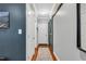 Hallway with hardwood floors, wainscoting, and rustic sliding barn door adding a touch of character at 262 Windgate Dr, Clayton, NC 27527