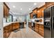 Kitchen with dark wood cabinets, white countertops, and stainless steel appliances at 262 Windgate Dr, Clayton, NC 27527