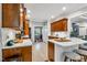 Open-concept kitchen with dark wood cabinetry, white subway tile backsplash, and an island with bar seating at 262 Windgate Dr, Clayton, NC 27527