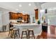 Kitchen with white countertops, dark wood cabinets, and a breakfast bar with seating at 262 Windgate Dr, Clayton, NC 27527